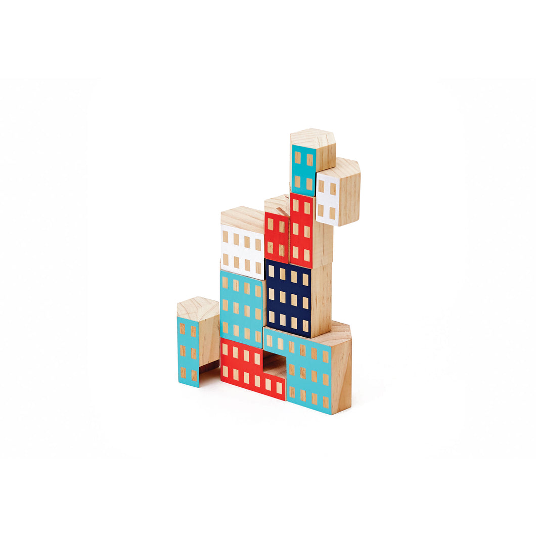 Hexagonal wooden blocks are stacked like a building. The blocks are painted white, red, light blue, and dark blue.