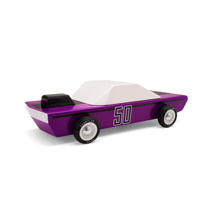 A wooden car painted purple with the number 50 stenciled on the side