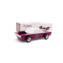 The purple wooden car is pictured in front of the package. The car has a white cab and the number 50 stenciled on the side.
