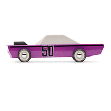 A side view of a purple car with a white cab. A black hood scoop is visible and a 50 is stenciled on the side of the car.