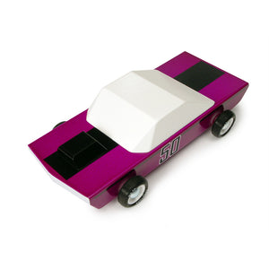 A top down view of a wooden car. The car has a purple body with a wide black racing strip on the hood and the trunk.