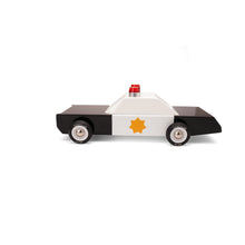 A modern looking wooden police car toy with real rubber tires, emergency lights, and a sheriff star painted on the door.