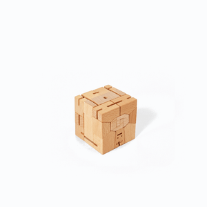 The wooden robot is folded into a perfect cube. It can be unfolded into a sturdy robot and posed thanks to it's elastic joints.