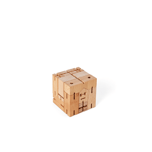 A wooden robot is shown folded into a perfect cube. The cube can be unfolded into a chunky wooden robot.